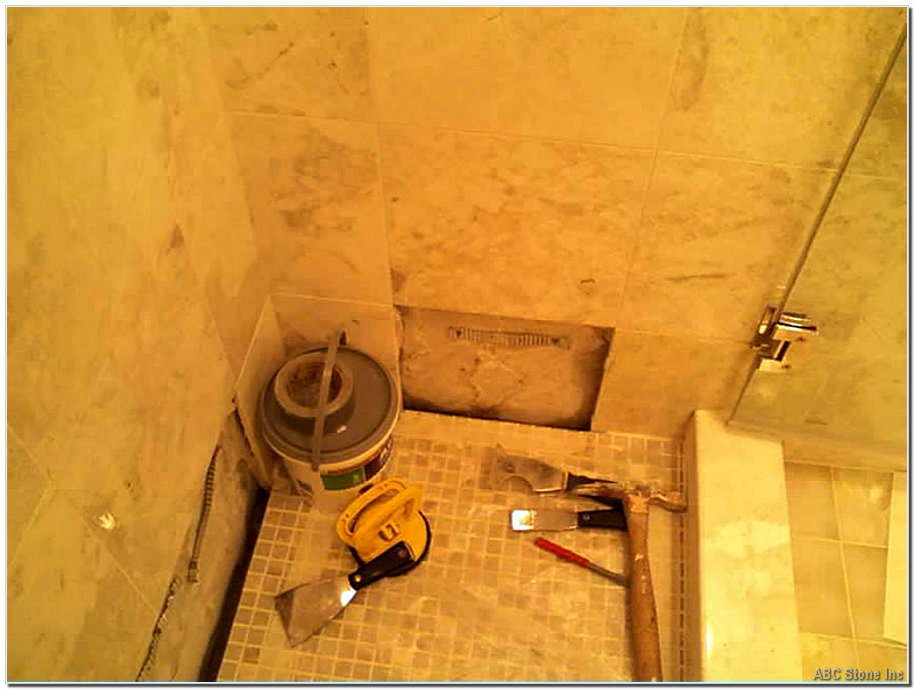 Bathroom shower wall with replaced tiles