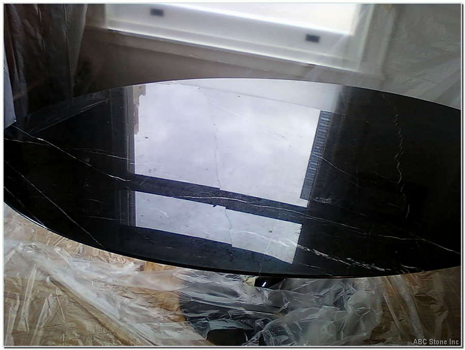 Close up image of a black marble tabletop with an internal crack