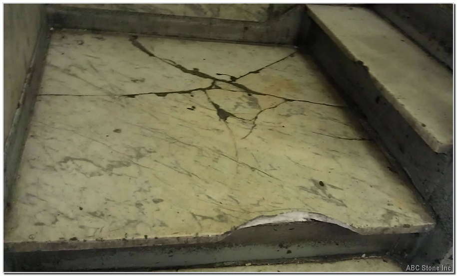 Damaged concrete landing slab with steps being repaired