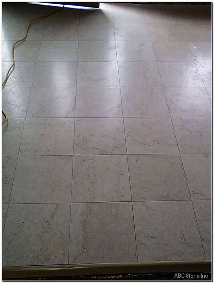 Before photo of an entrance with marble floor