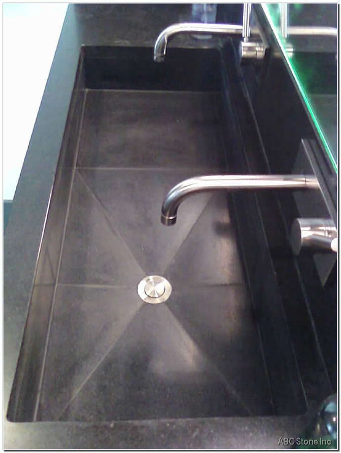 Black granite sink with grout repair needed