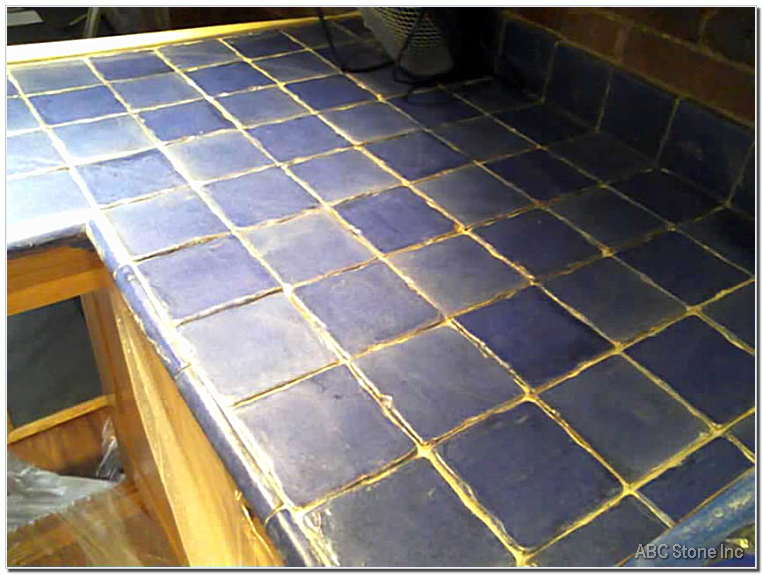 Tiled kitchen counter surface before regrouting process
