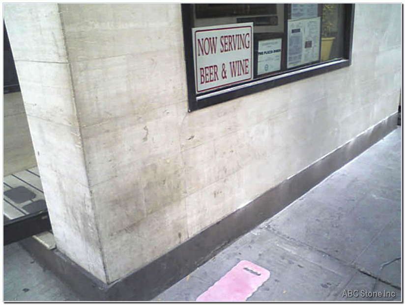 Photo of a storefront made of travertine before cleaning