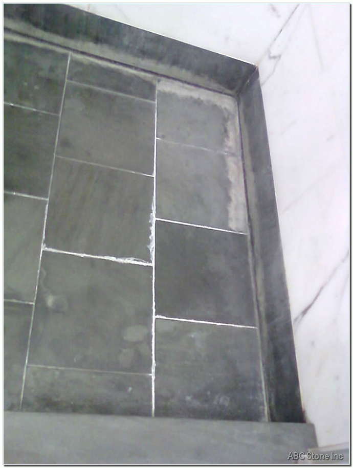 Marble shower floor with water deposits