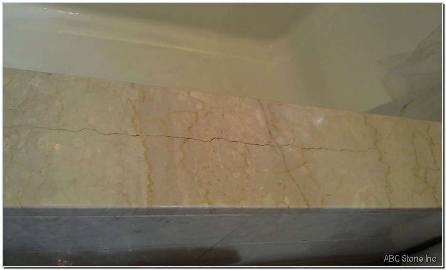 Cracked marble top of a bathtub