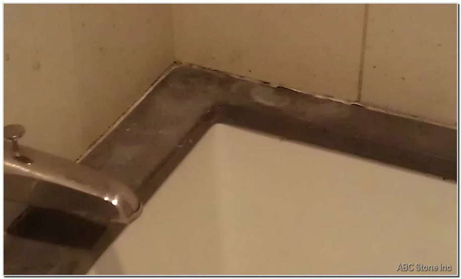 Erosion damage on the surface of a bathtub