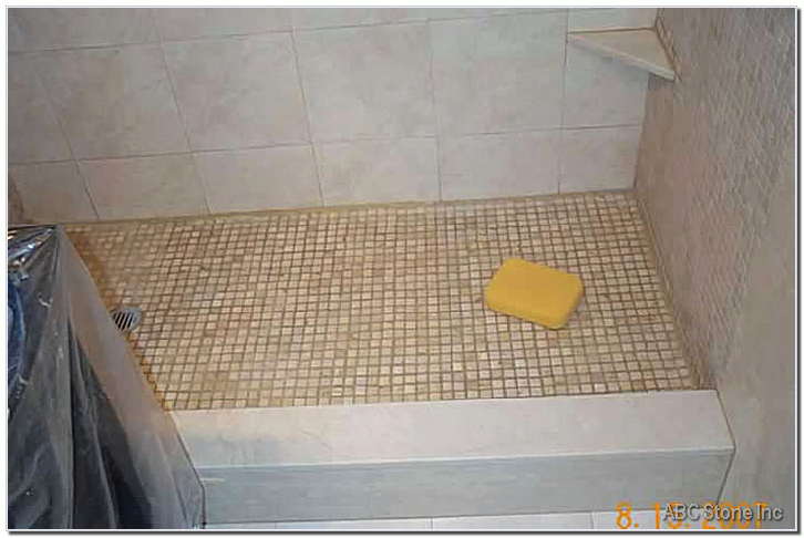 Shower floor with mosaic tiles being sealed