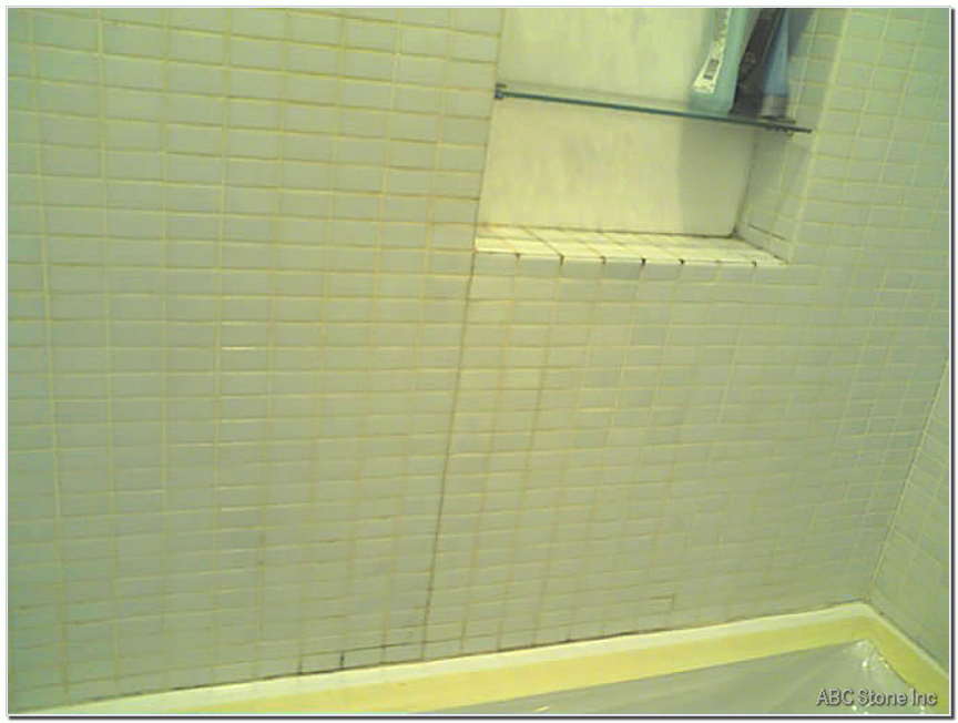 Image of tiles being regrouted and repaired before